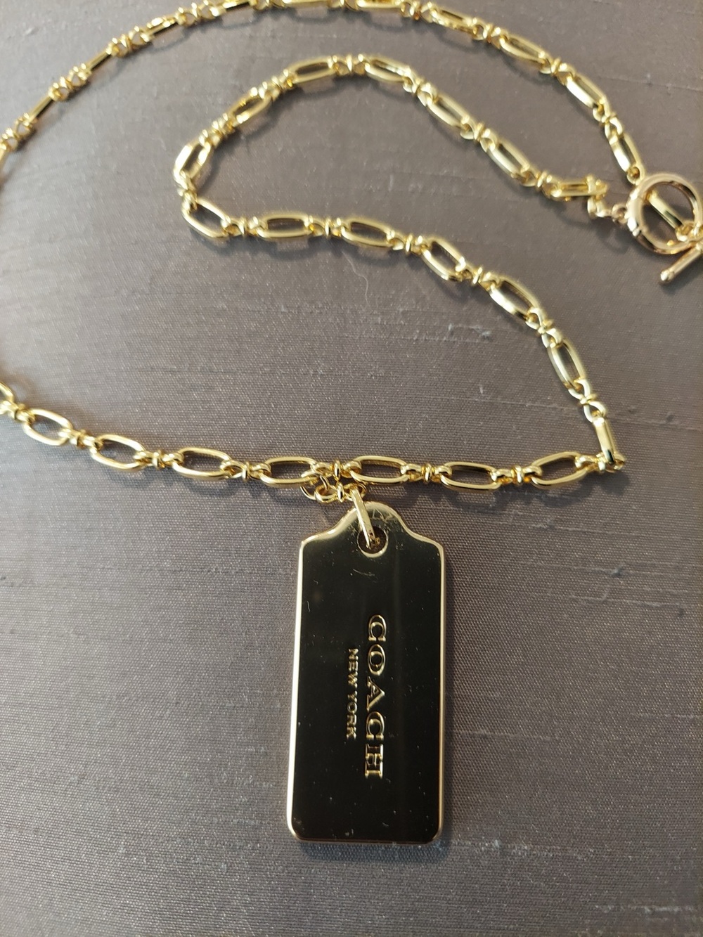 Coach Gold-tone Authentic Tag Pendant Necklace on a 20” 18k Gold-Plated Chain